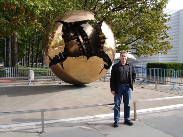 Charl standing in front of the Sphere within a sphere statue